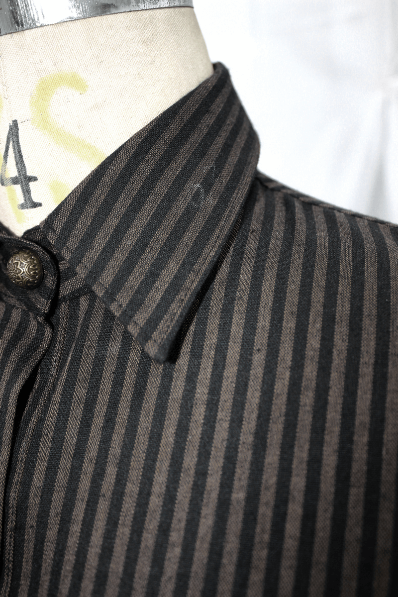 Close-up of a stylish striped blouse collar with buttons, highlighting vintage design elements for a chic steampunk look.