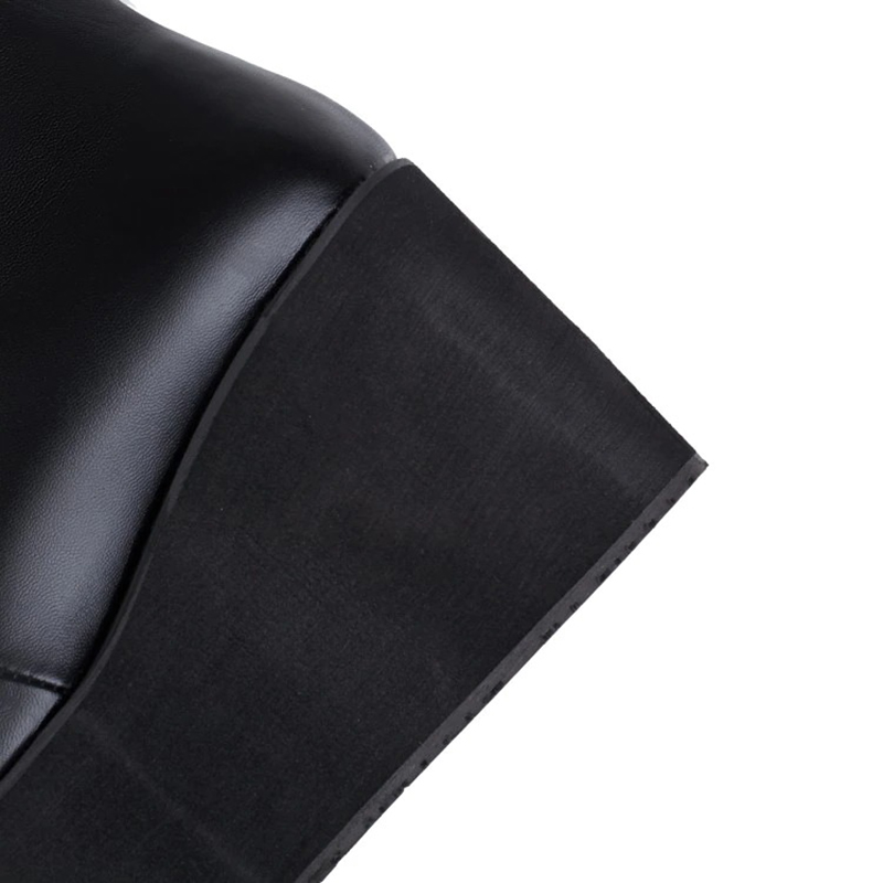 Close-up of women's gothic black platform boot showing thick bottom and sleek design for stylish punk fashion.