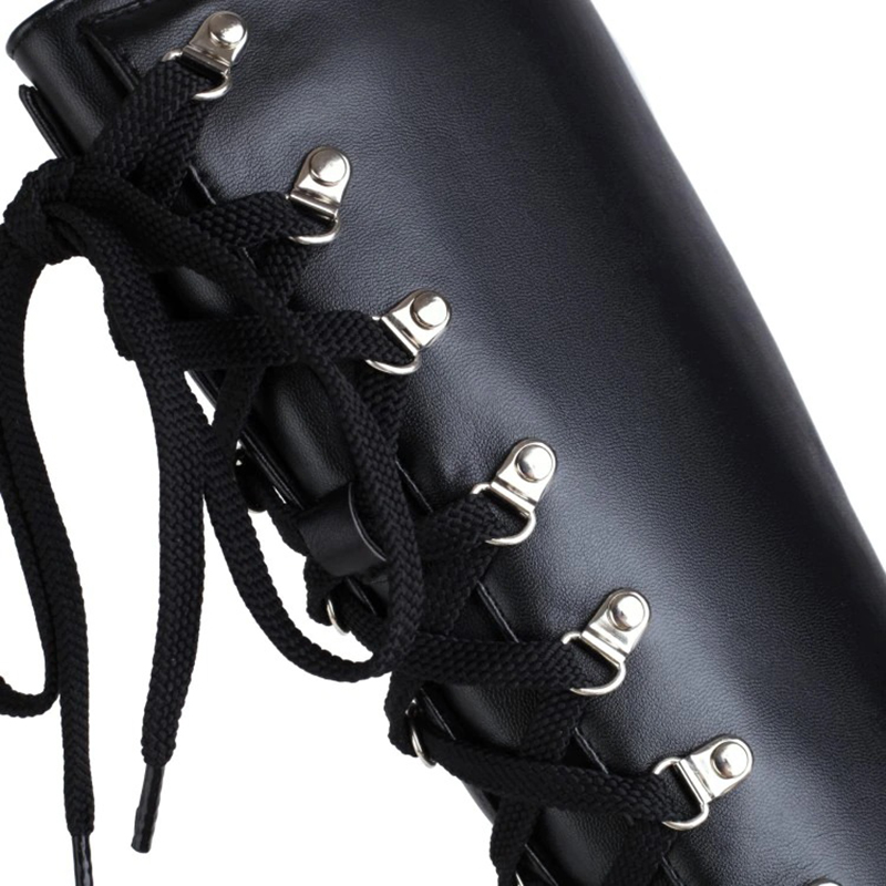 Close-up of women's gothic black lace-up boots showing stylish silver rivets and thick laces for a punk fashion statement.