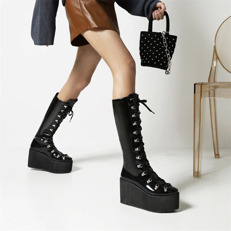 Women's gothic black platform boots with lace-up design and thick bottom for a trendy punk style.