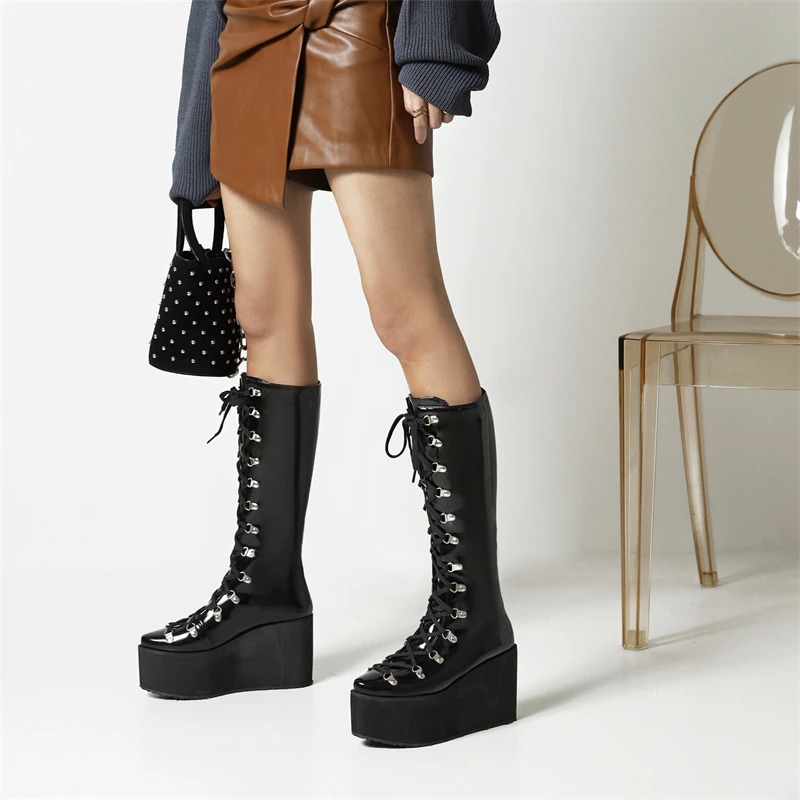 Stylish women's super high black punk boots with lace-up design and thick platform for a trendy look.