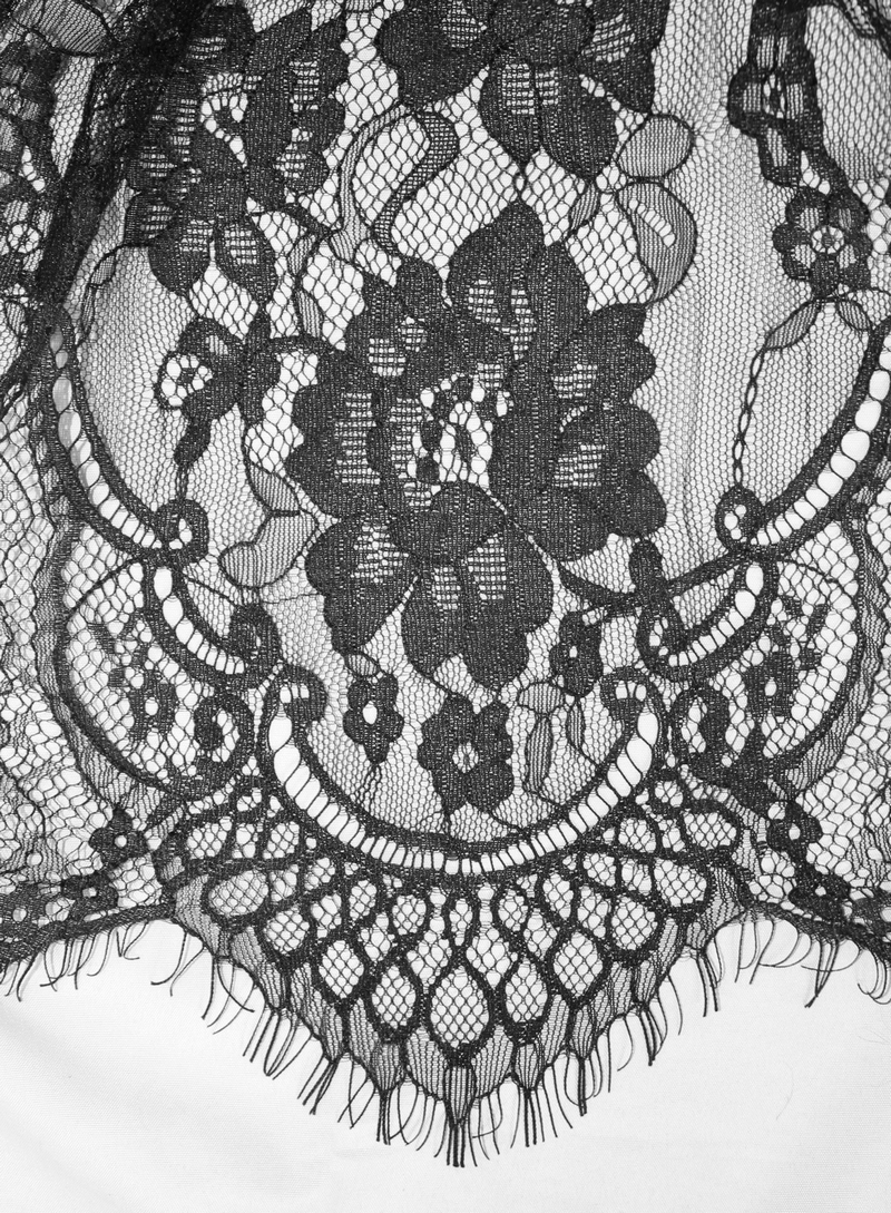 Detailed black lace fabric featuring floral patterns and intricate designs for elegant gothic fashion.