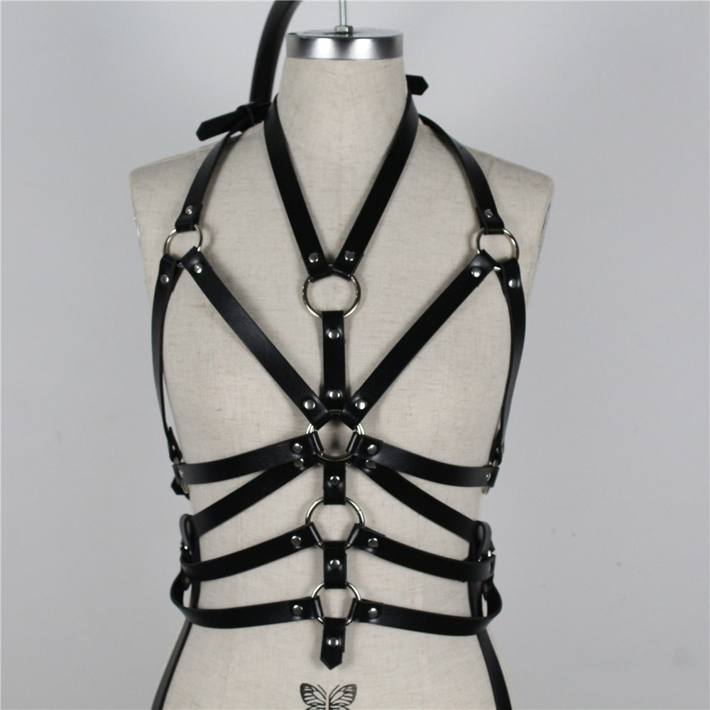 Women's black bondage garter belt with metal rings for gothic fashion, perfect for a fierce and sexy look.
