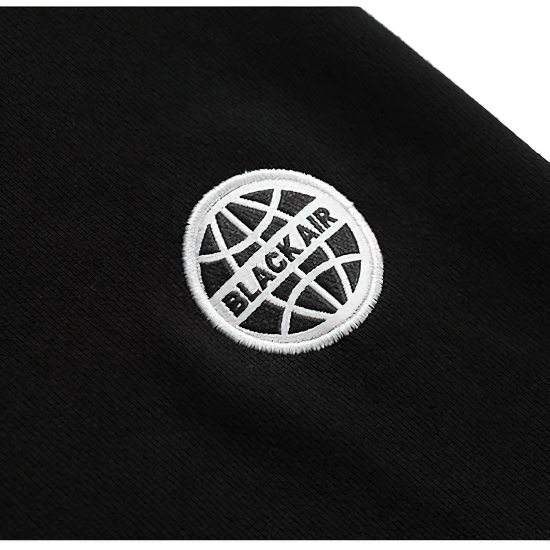Close-up of the BLACK AIR logo embroidered on a stylish black sweatshirt, showcasing trendy casual wear.