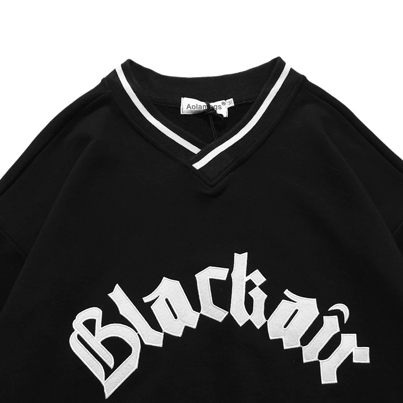 Women's V-neck black sweatshirt featuring stylish letter patch and trendy design, perfect for casual wear.