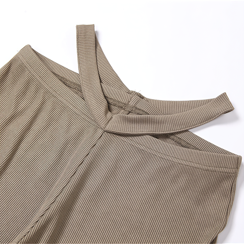 Close-up of women's vintage high waist pants in timeless beige, featuring a stylish cross-back design.