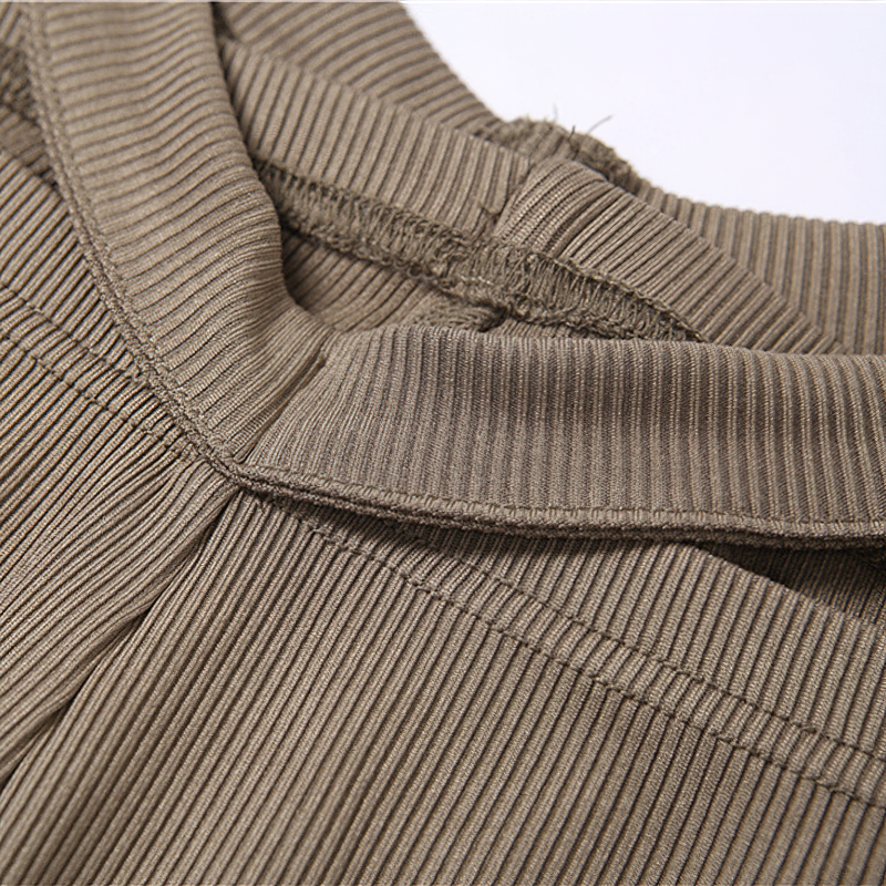 Close-up of the textured fabric and waistband of women's vintage gothic style high waist pants.