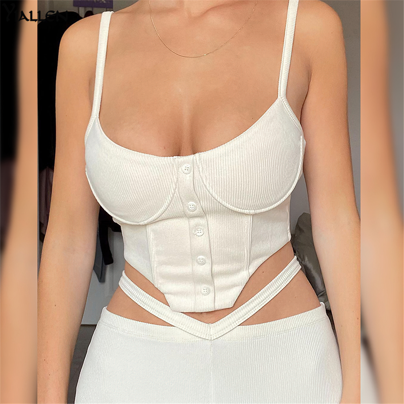 Stylish white ribbed crop top with buttons, featuring adjustable straps and a trendy cut-out design.