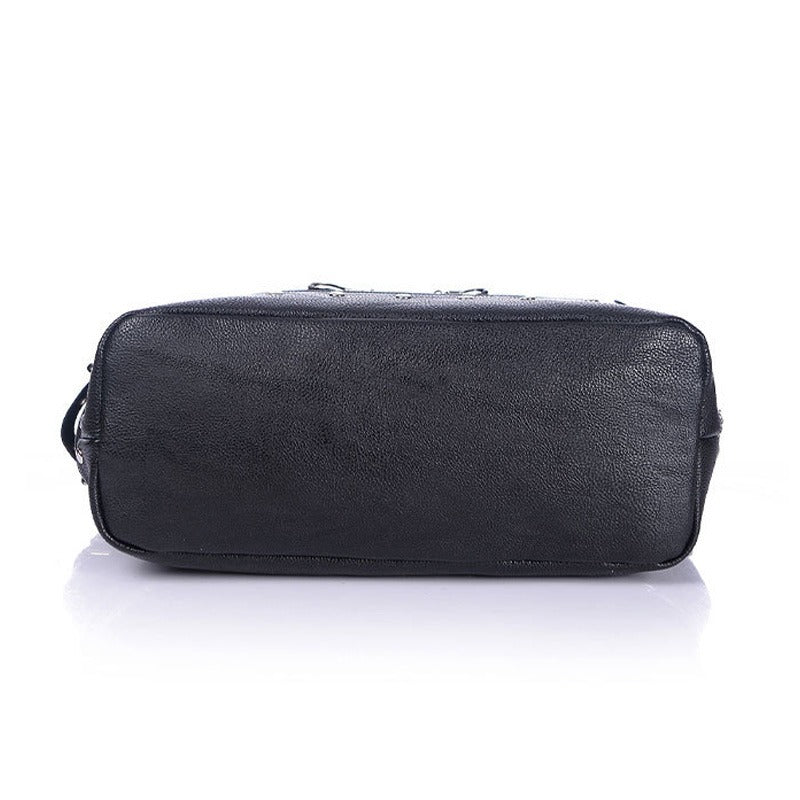 Bottom view of a women's vintage rivet tote bag in black canvas with zippers and chains, showcasing unique gothic style details.