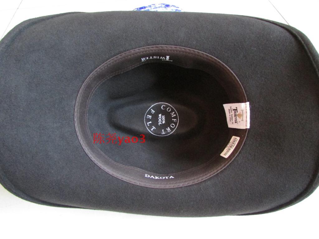 Inside view of a black wool bowler hat showing comfortable lining and brand tags, perfect for cowboy and rock fashion.
