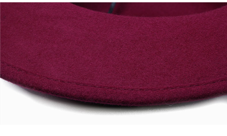 Close-up of a burgundy woollen fedora hat highlighting its soft felt texture.