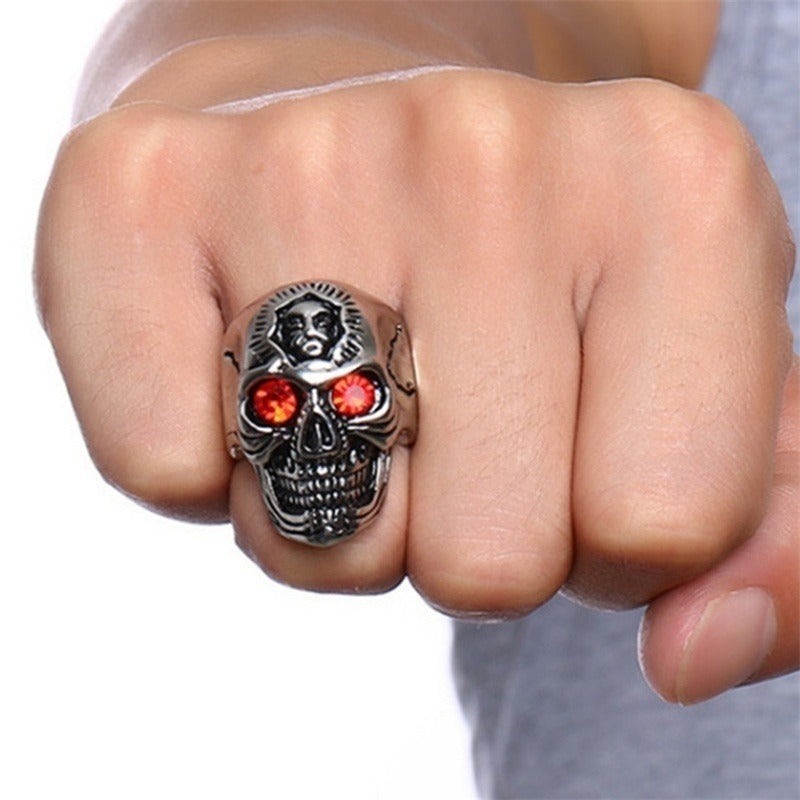 Zinc alloy gothic skull ring with red zirconia stones worn on a fist, showcasing an edgy biker punk rock style.