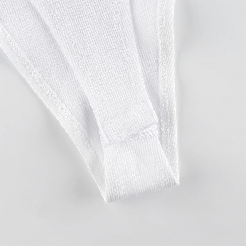 Close-up view of a white bodysuit strap showing textured fabric and stitching details, perfect for stylish summer wear.
